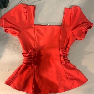 Vermillion colored blouse for women.